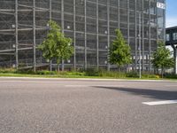 there is a very large building on this street corner, so it is empty except the cars and the buildings