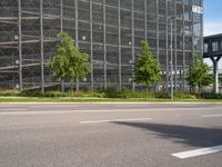 there is a very large building on this street corner, so it is empty except the cars and the buildings