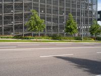 there is a very large building on this street corner, so it is empty except the cars and the buildings