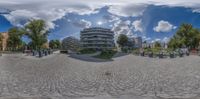 a fish eye lens panoramic view of a building and park area from an individual perspective