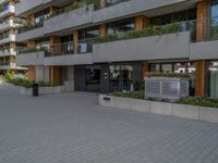 a view of a city street and a residential building from the outside with no roof