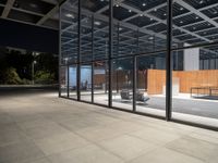 the glass doors on this building provide privacy and sunlight to the space below, while sitting in a chair