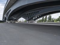 a motorcycle under an overpass with trees in the background, a bike is parked under it