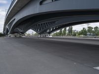 a motorcycle under an overpass with trees in the background, a bike is parked under it