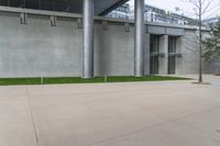 a white fire hydrant sitting outside a building with concrete walls and floors to the side