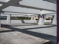 the parking garage is very empty and clean, with all white walls and windows visible