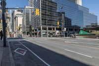 empty city street in an urban area with a lot of tall buildings in the background