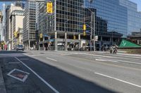 empty city street in an urban area with a lot of tall buildings in the background