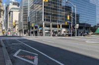 empty city street in an urban area with a lot of tall buildings in the background