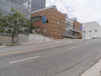 an empty street is shown in front of the museum's building and sidewalk with an empty bench