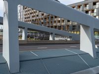 a walkway crossing over the top of a building with a roof on one side and the other