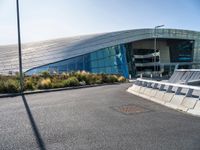 a large building near a road in front of a building with a lot of windows