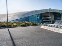 a large building near a road in front of a building with a lot of windows