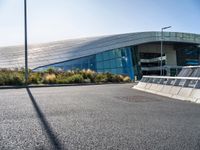 a large building near a road in front of a building with a lot of windows