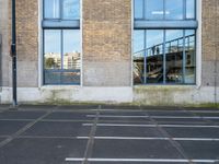 a parking lot with a fire hydrant and graffiti on the wall next to an outside building