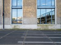 a parking lot with a fire hydrant and graffiti on the wall next to an outside building