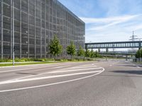 a street with an empty highway and a building that looks like a building with lots of windows