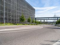 a street with an empty highway and a building that looks like a building with lots of windows