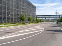 a street with an empty highway and a building that looks like a building with lots of windows