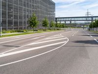 a street with an empty highway and a building that looks like a building with lots of windows