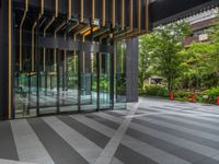 a walkway leading up to a wooden wall next to a cement area with floor tiles