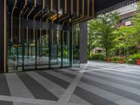 a walkway leading up to a wooden wall next to a cement area with floor tiles