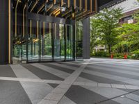 a walkway leading up to a wooden wall next to a cement area with floor tiles