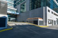 an empty paved walkway by a building on a sunny day with no people walking around