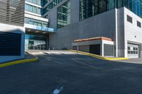 an empty paved walkway by a building on a sunny day with no people walking around