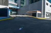 an empty paved walkway by a building on a sunny day with no people walking around