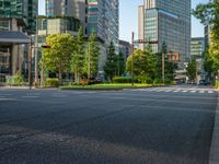 an empty road with a street sign at the curb in front of an office building