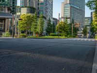 an empty road with a street sign at the curb in front of an office building