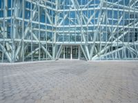 a view from the outside looking towards an office building and its outside glass walls are reflecting the sun