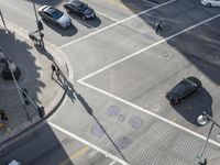 a crosswalk in a city with a street scene next to it and pedestrians and cars in a city