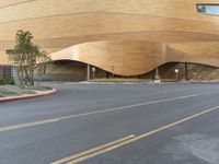 a building with curved windows sitting on the side of the road next to a street