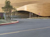 a building with curved windows sitting on the side of the road next to a street