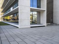 an outside building with concrete floors and an empty bench in the middle of the photo