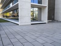 an outside building with concrete floors and an empty bench in the middle of the photo