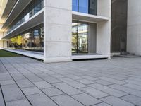 an outside building with concrete floors and an empty bench in the middle of the photo