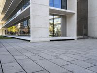 an outside building with concrete floors and an empty bench in the middle of the photo