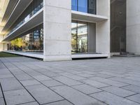 an outside building with concrete floors and an empty bench in the middle of the photo