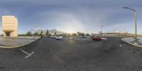 a car that is driving around in the street corner is a reflection in a fish eye view mirror