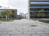 a view of the public area next to several office buildings with trees and other buildings