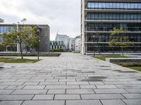 a view of the public area next to several office buildings with trees and other buildings