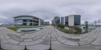 the image shows a photo with an oval lens of a reflection of several buildings in the background