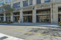 a person walks past a building with art on the sidewalk with graffiti on the walls