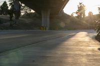 a view of an intersection on a sunny day with the sun shining on it and trees