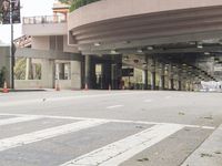 a yellow bicycle sits parked under a bridge in an empty city space for pedestrians and pedestrians