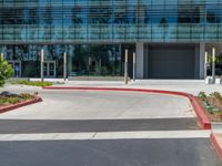 two grey blocks sitting next to a tall building on a sidewalk in front of grass