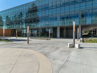 two grey blocks sitting next to a tall building on a sidewalk in front of grass